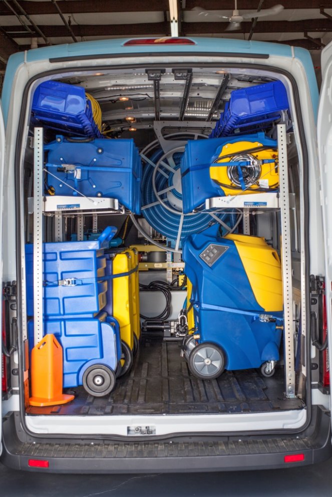 The interior of a company van fully loaded with water damage restoration equipment for 1-800 WATER DAMAGE of Oklahoma City, OK.