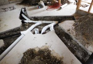 Interior drainage system installation with pipes in a basement by Waterdry Indiana in South Bend, IN