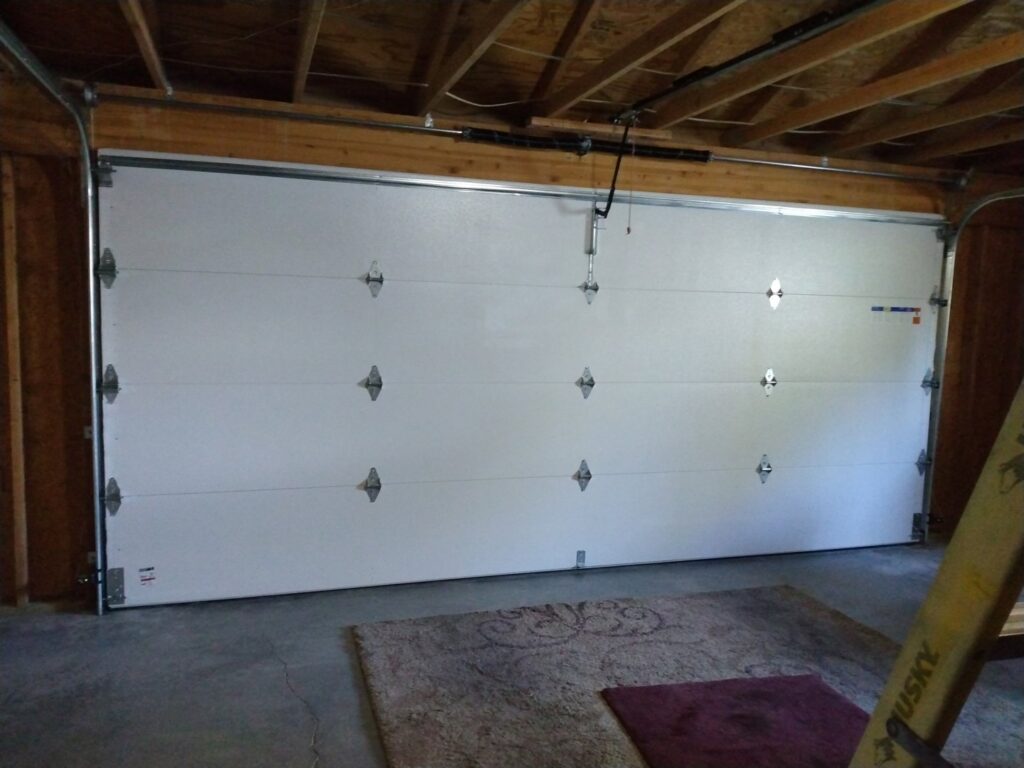An interior view of a newly installed white garage door by Cactus Garage Doors, Inc. in North Las Vegas, NV.