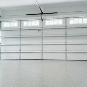 Interior view of a white sectional garage door showing tracks and opener mechanism by Oahu Garage Doors in Waipahu, HI