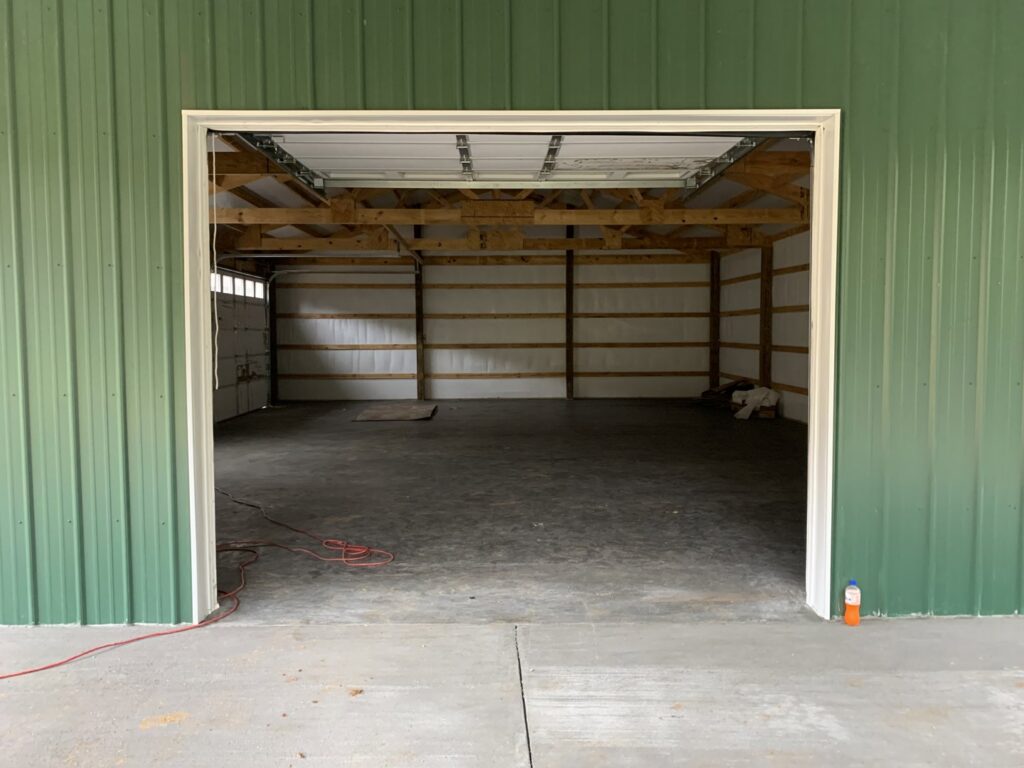 Interior view of a garage door opening with tracks and framing visible, showcasing work by LaFrancis Overhead Door LLC in Little Rock, AR