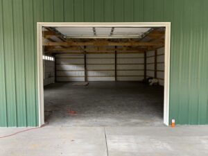 Interior view of a garage door opening with tracks and framing visible, showcasing work by LaFrancis Overhead Door LLC in Little Rock, AR