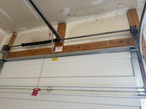 An interior view of a garage door displaying the torsion spring system and tracks by A-1 Garage Door Repair in Syracuse, UT.