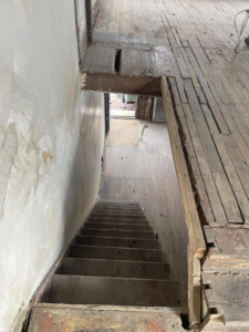 Interior gutting project with exposed floorboards and a staircase, handled by Identical Demolition LLC in Philadelphia, PA.