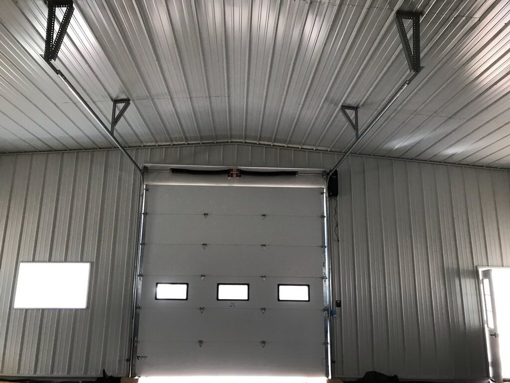 Interior view of an industrial garage door and opener system installed by Ski Door, Inc. in Center Rutland, VT.