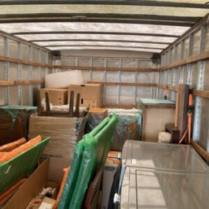 The interior of a Prime Moving truck, expertly packed with furniture and boxes for transport in Boston, MA.