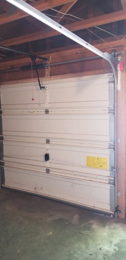 Interior view of a garage door showing its structure, possibly indicating damage or a need for repair by Sandia Garage Door Repair in Albuquerque, NM