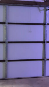 Interior view of a white garage door, showcasing the panels and bracing installed by LaFrancis Overhead Door LLC in Little Rock, AR