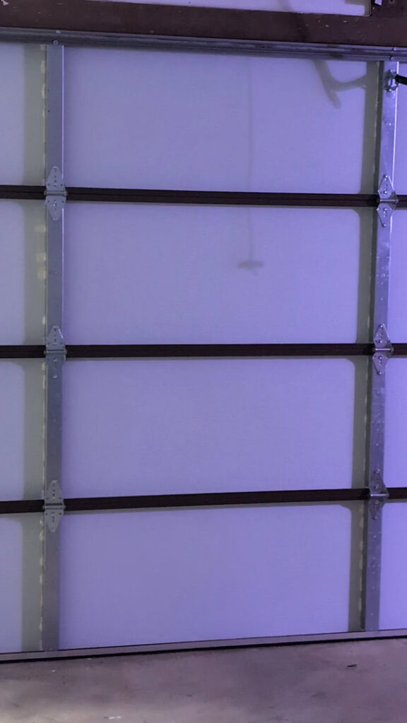 Interior view of a white garage door, showcasing the panels and bracing installed by LaFrancis Overhead Door LLC in Little Rock, AR