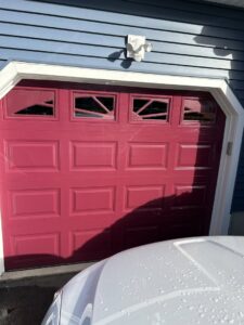 Interior view of a white garage door showing tracks and hardware installed by Compton Doors, Inc. in Attleboro, MA