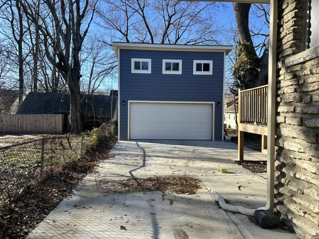 Interior view of a white garage door showing tracks and opener mechanism by Summit Garage Door in Overland Park, KS.