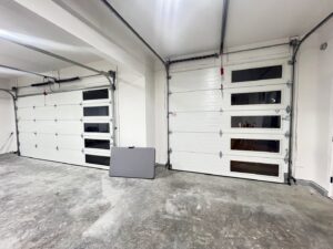 Interior view of two white garage doors featuring multiple windows, installed by Elite Doors in Wasilla, AK.