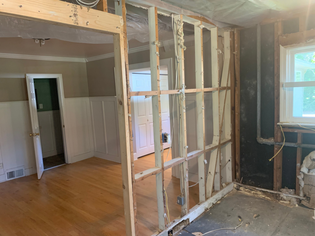 An interior wall removed, exposing framing and opening up a room, by Clean Slate Demolition in Rock Hill, SC.