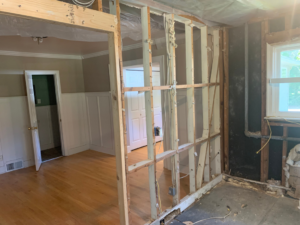 An interior wall removed, exposing framing and opening up a room, by Clean Slate Demolition in Rock Hill, SC.