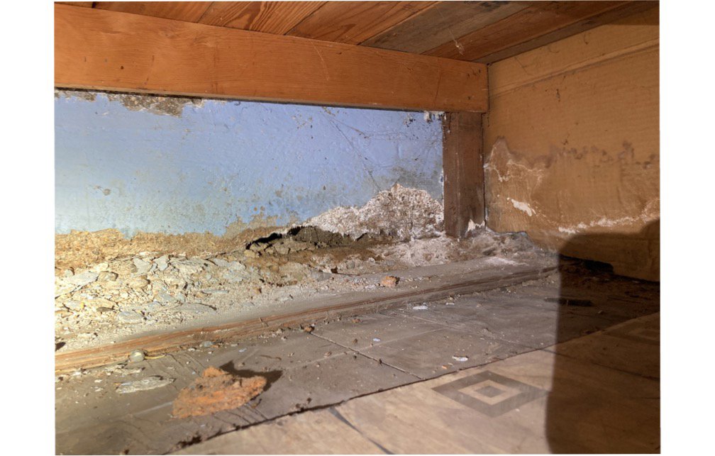 Interior wall with severe water stains, peeling paint, and efflorescence, indicating water damage for Double H Inspections in Sheridan, WY