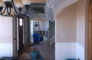 Interior of a home undergoing water damage drying with air movers and plastic sheeting by Dayspring Restoration in Butte, MT