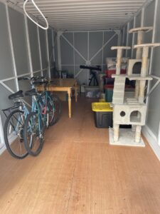 Various household items, including bicycles and a table, neatly arranged inside a storage container by Next Step Moving in Eau Claire, WI.