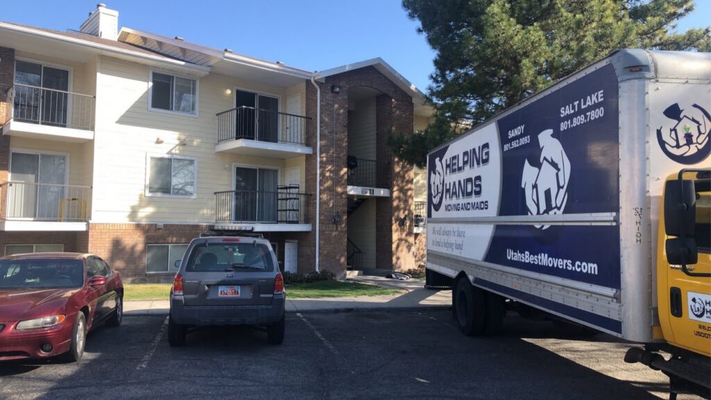 Various household items and furniture wrapped for moving in a garage by Helping Hands Moving & Maids in Salt Lake City, UT.