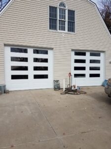 The JLM Garage Doors Omaha service van parked in front of a residential home, ready for a garage door job in Papillion, NE.