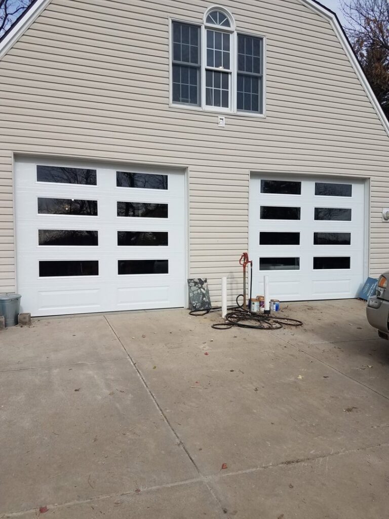 The JLM Garage Doors Omaha service van parked in front of a residential home, ready for a garage door job in Papillion, NE.