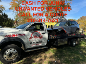 A tow truck from Av towing llc providing junk car removal service for a grey SUV in Cleveland, OH.
