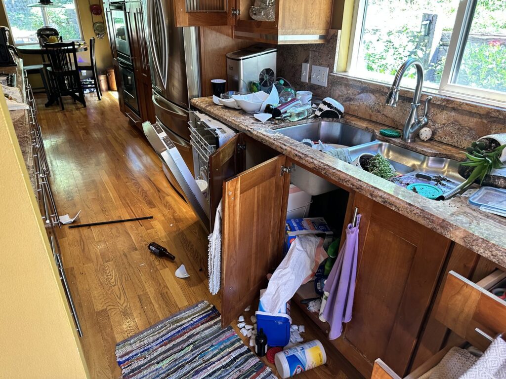 A kitchen in disarray after a water leak, requiring cleanup and restoration by Peak Restoration in Sandy, UT.