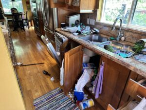 A kitchen in disarray after a water leak, requiring cleanup and restoration by Peak Restoration in Sandy, UT.