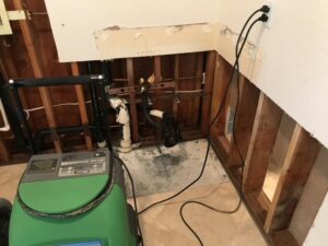 Kitchen cabinet area with drywall removed for water damage restoration by Best Dry Flood and Mold Specialists, Inc. San Diego, CA