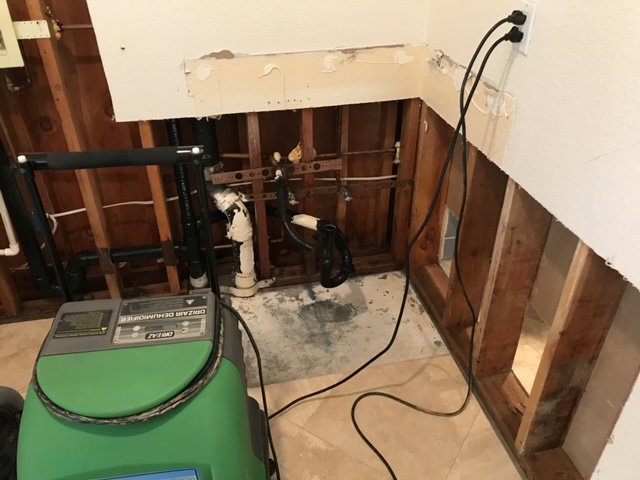 Kitchen cabinet area with drywall removed for water damage restoration by Best Dry Flood and Mold Specialists, Inc. San Diego, CA