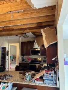 A kitchen with a collapsed ceiling and debris from severe water damage, ready for restoration by Triple Crown Restoration in Covington, KY