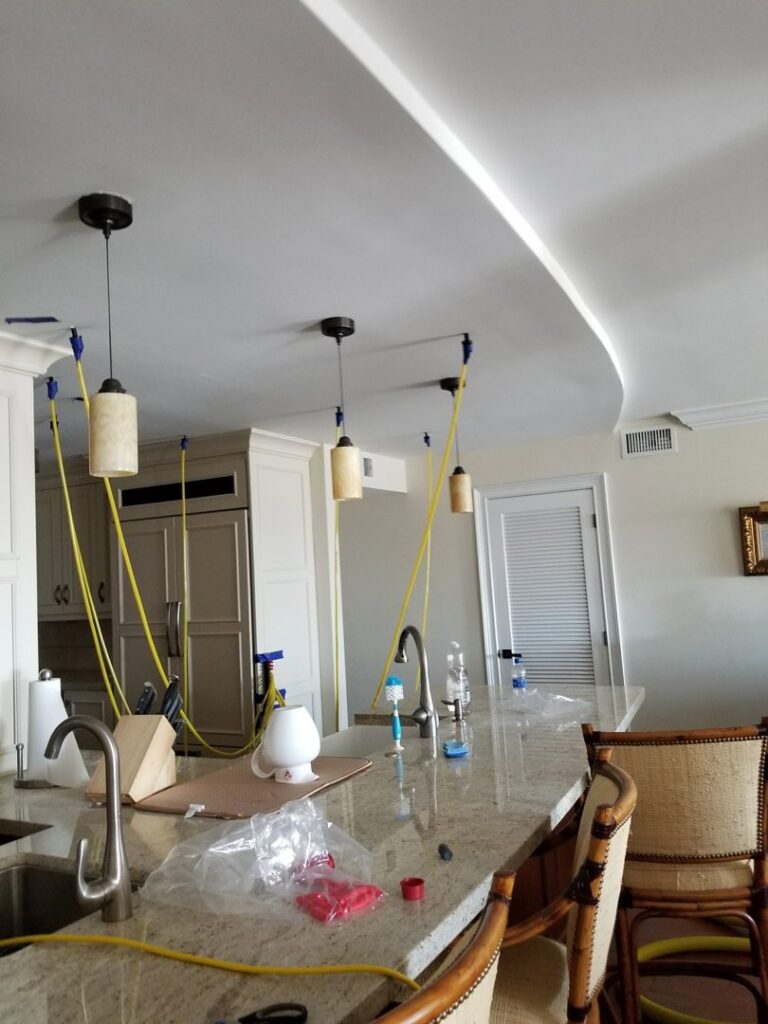 Hoses and equipment set up for deep kitchen cleaning by RK Cleaning Services in a Fort Lauderdale, FL home.