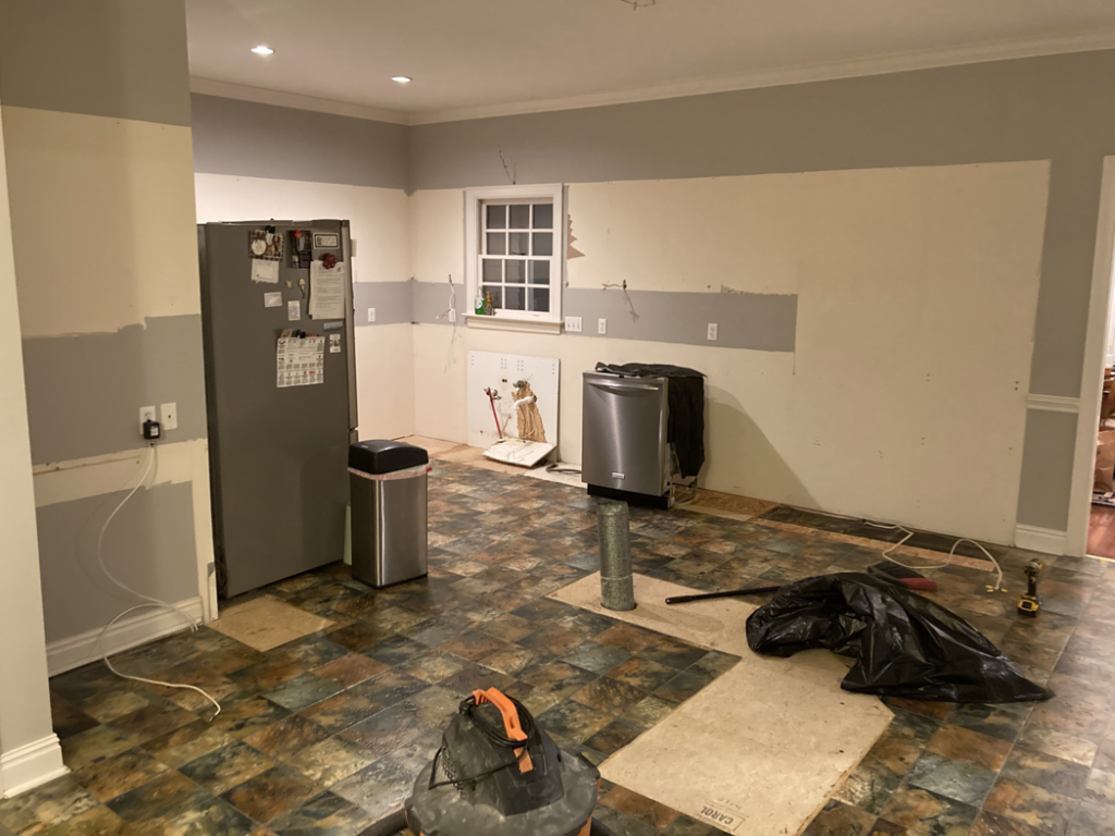 A kitchen undergoing demolition with walls stripped and floor exposed by Clean Slate Demolition in Rock Hill, SC.