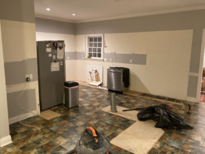 A kitchen undergoing demolition with walls stripped and floor exposed by Clean Slate Demolition in Rock Hill, SC.