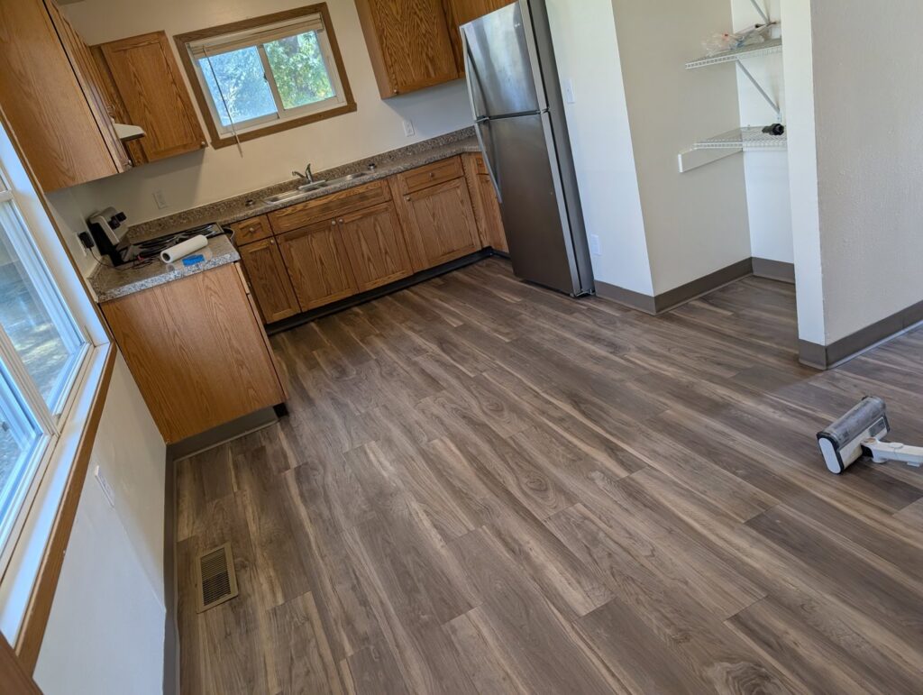 A clean kitchen floor with a floor cleaning tool, showcasing services by Clean and Pristine Solutions in Fargo, ND.