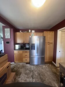 A kitchen undergoing floor demolition and cabinet removal for water damage restoration by The Corvallis Contractor in Corvallis, OR.