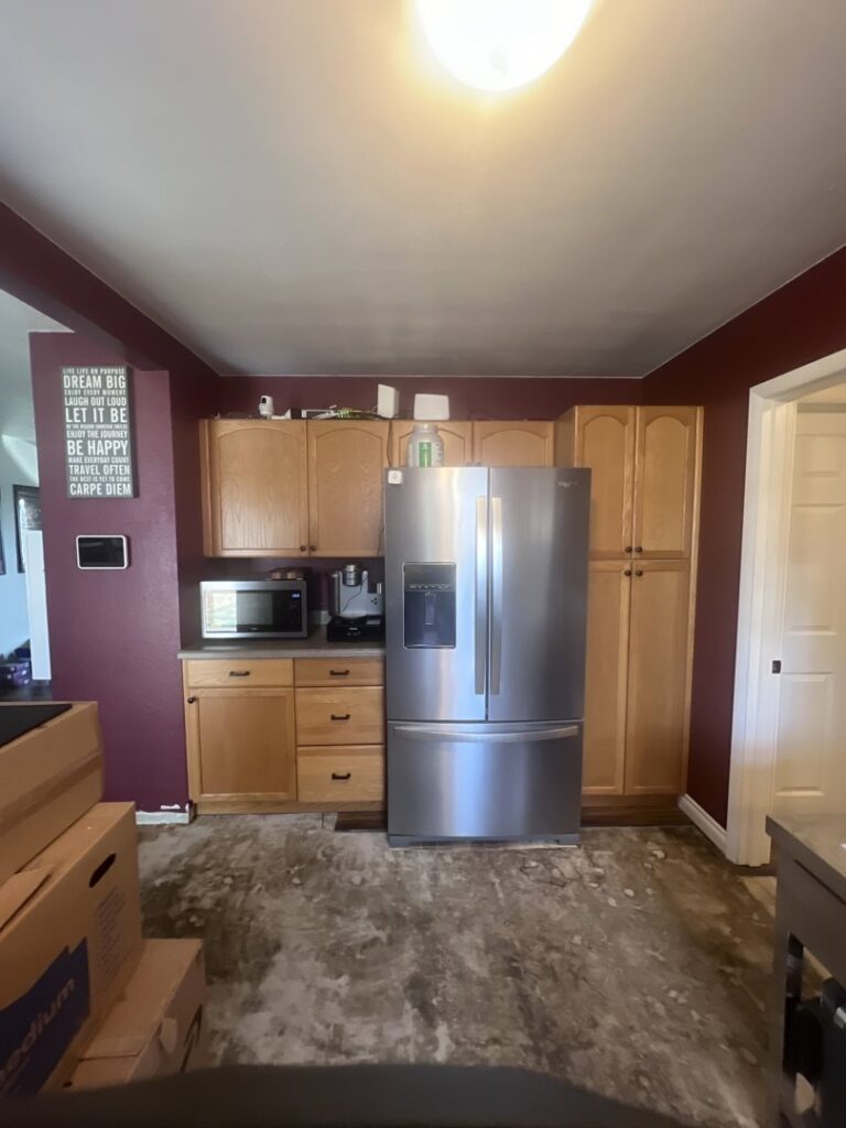 A kitchen undergoing floor demolition and cabinet removal for water damage restoration by The Corvallis Contractor in Corvallis, OR.