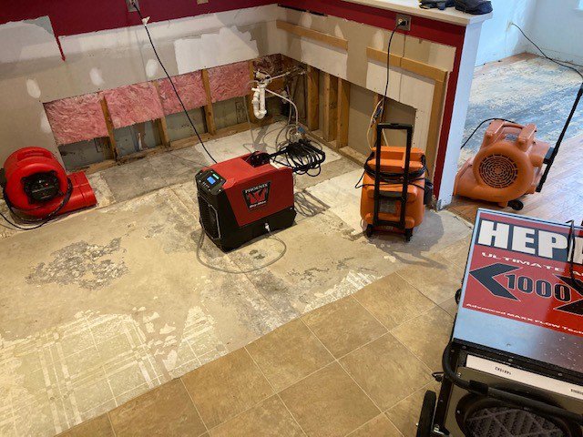 A kitchen undergoing water damage demolition and drying with walls removed by CleanBright Surface Restoration in Latham, NY.
