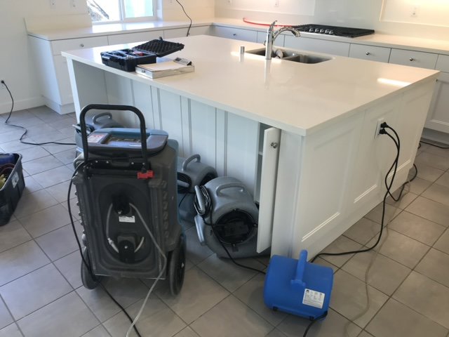 Kitchen water damage drying with a dehumidifier and air movers by Best Dry Flood and Mold Specialists, Inc. San Diego, CA