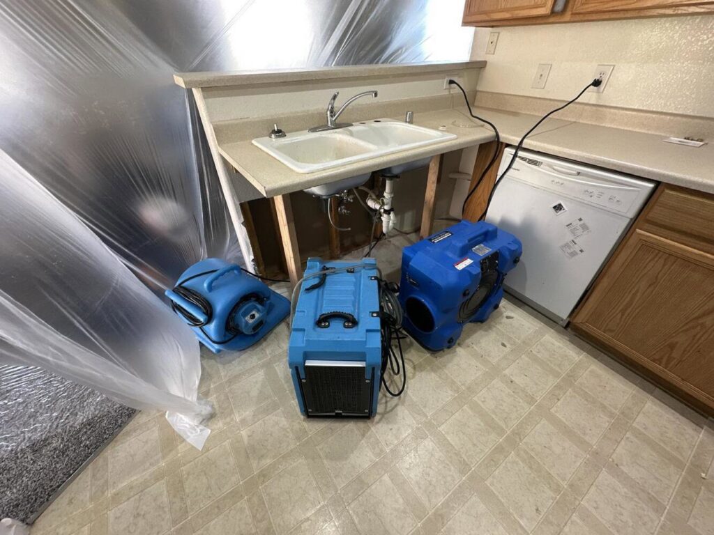Water damage drying equipment in a kitchen undergoing restoration by APEX Restoration in Mililani, HI