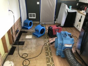 Kitchen undergoing water damage drying with air movers and dehumidifiers by Complete Restoration and Construction, LLC in Yakima, WA