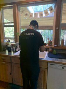 Water damage drying equipment, including air movers and dehumidifiers, in a kitchen by Paul Davis Restoration in Vancouver, WA