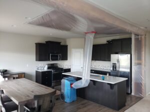 A kitchen undergoing water damage drying with specialized equipment by PacWest Restoration in Tigard, OR