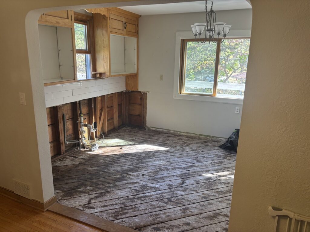 Kitchen with lower cabinets removed and subfloor exposed for water damage remediation by Restoration Network Inc in Maple Grove, MN.