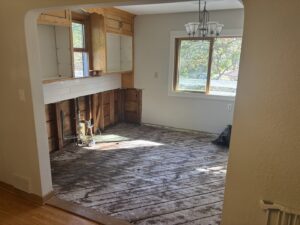 Kitchen with lower cabinets removed and subfloor exposed for water damage remediation by Restoration Network Inc in Maple Grove, MN.