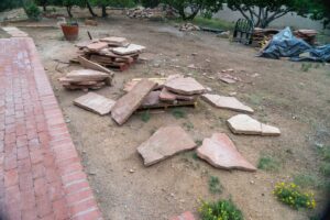 Landscaping materials including stone slabs and pallets ready for a hardscaping project by Pro Scape in Eustis, FL.