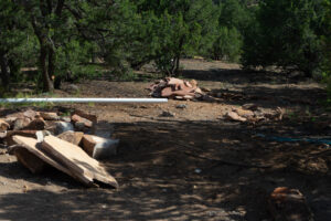 Landscaping site preparation with stone slabs and a white pipe for a new project by Pro Scape in Eustis, FL.