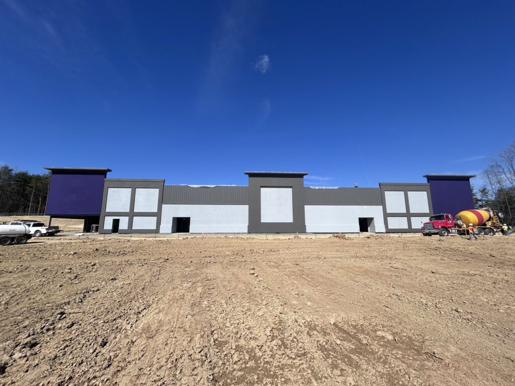 Large commercial building under construction with extensive stucco siding work by Eastern Stucco Restorations in Rock Hill, SC.