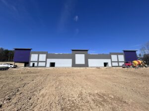 Large commercial building under construction with extensive stucco siding work by Eastern Stucco Restorations in Rock Hill, SC.