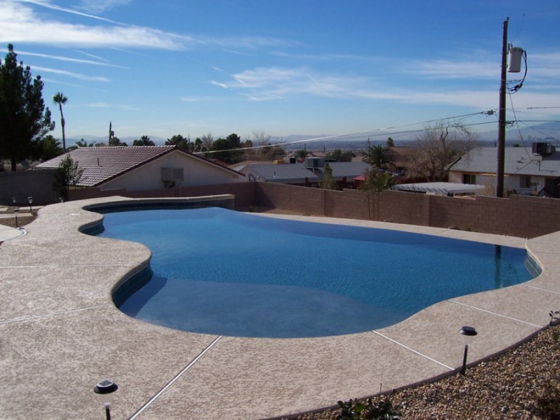 A spacious freeform backyard pool with a scenic view, constructed by Steve Breck Pools in Las Vegas, NV.
