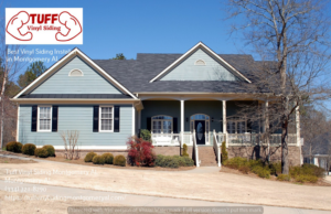 A large residential house showcasing light blue vinyl siding and a brick foundation by Tuff Vinyl Siding Montgomery Al in Montgomery, AL.